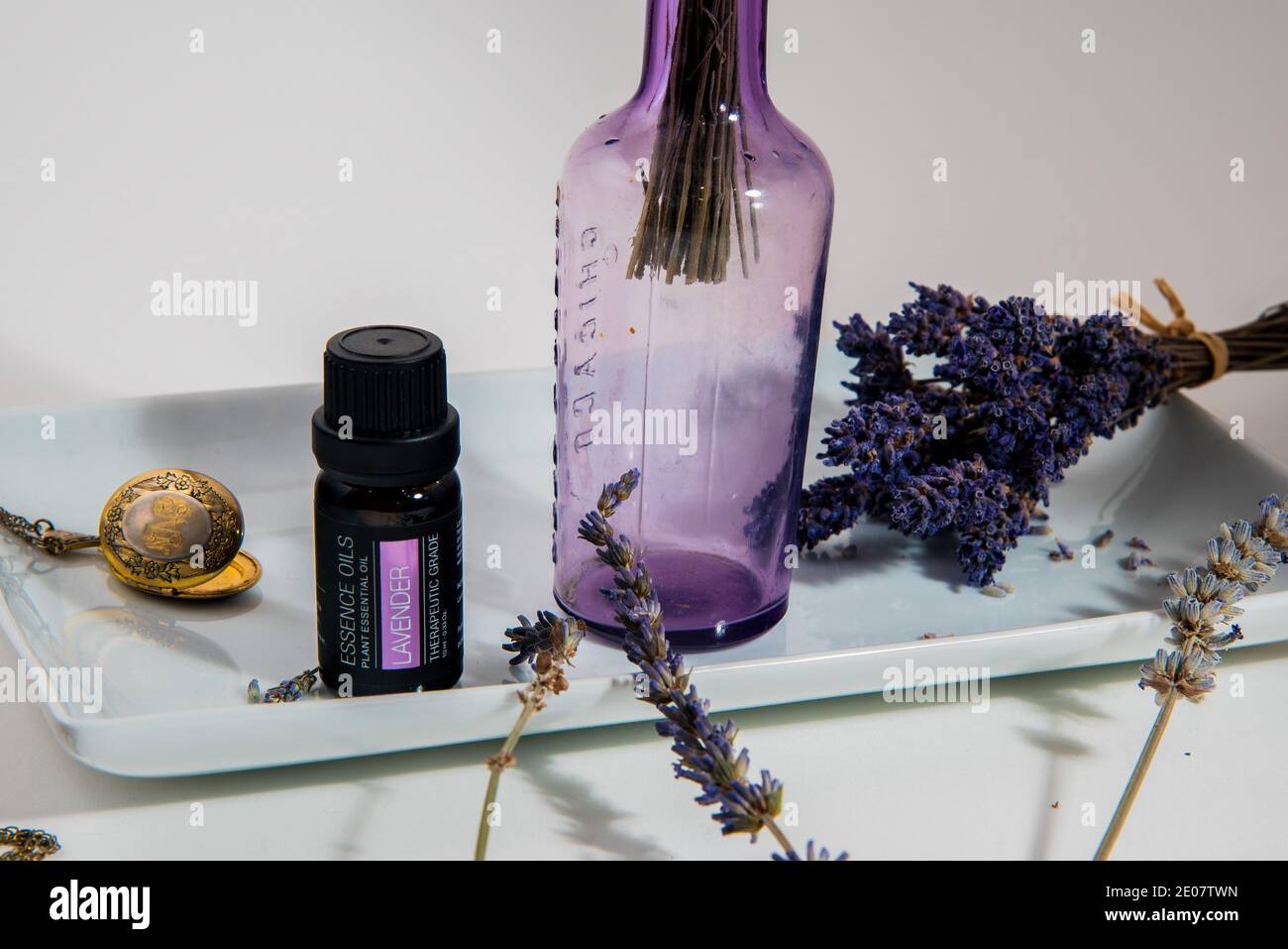 Lavender plants in bottles with essential oils, on a white background ...