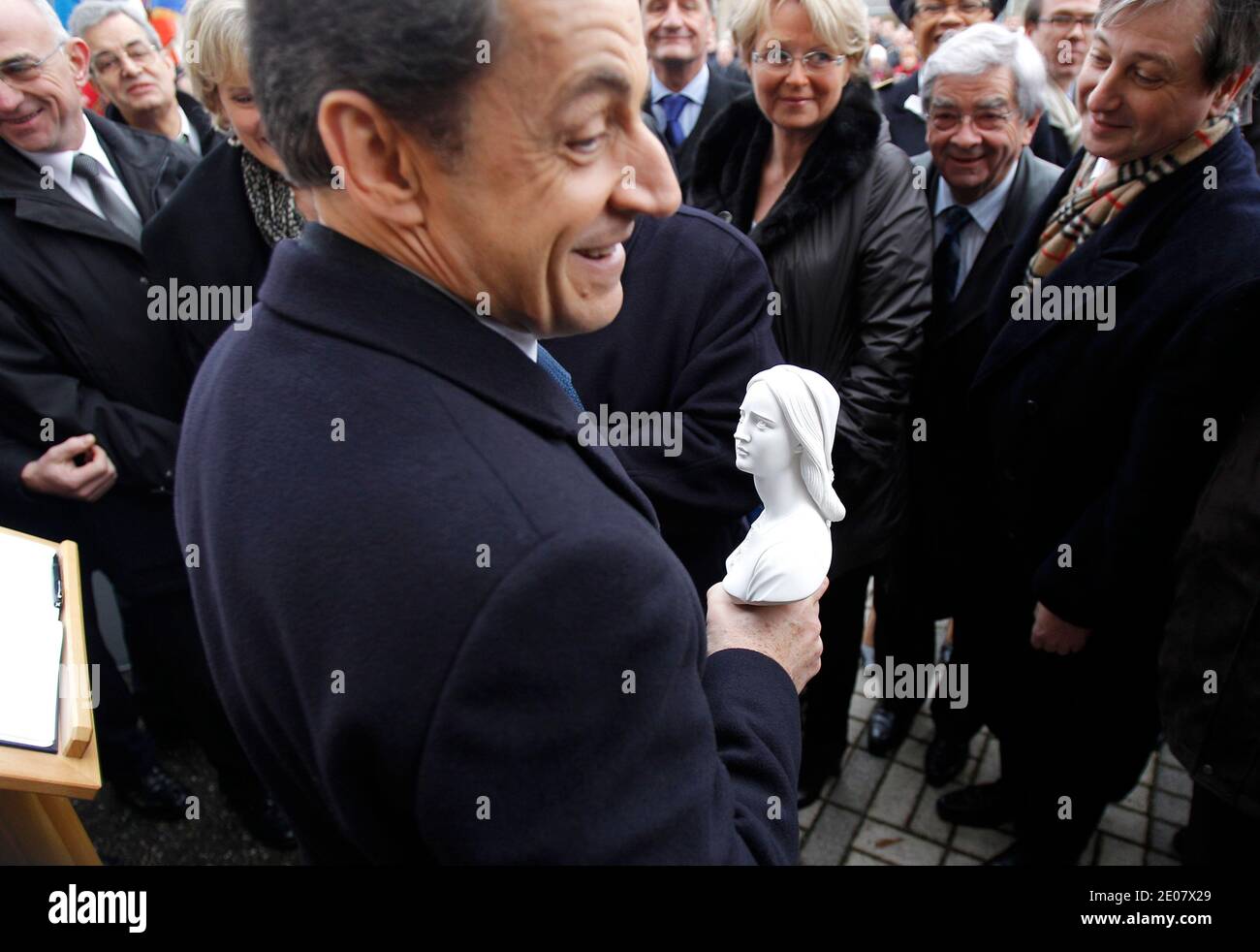 French President Nicolas Sarkozy, hold a bust of Jeanne D'Arc which he received from local officials during celebrations of the 600th anniversary of the birth of French heroine Jeanne D'Arc in Domremy, eastern France, on January 6, 2012. Jeanne D'Arc a 15th century Catholic martyr, a teenage peasant who led the French army against the English after experiencing religious visions and was later burned at the stake, has in recent years become a symbol of the populist right. Photo by Michel Euler/Pool/ABACAPRESS.COM Stock Photo