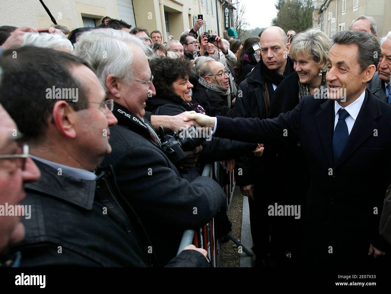 French President Nicolas Sarkozy, shakes hands with bystanders during celebrations of the 600th anniversary of the birth of French heroine Jeanne D'Arc in Domremy, eastern France, on January 6, 2012. Jeanne D'Arc a 15th century Catholic martyr, a teenage peasant who led the French army against the English after experiencing religious visions and was later burned at the stake, has in recent years become a symbol of the populist right. Photo by Michel Euler/Pool/ABACAPRESS.COM Stock Photo