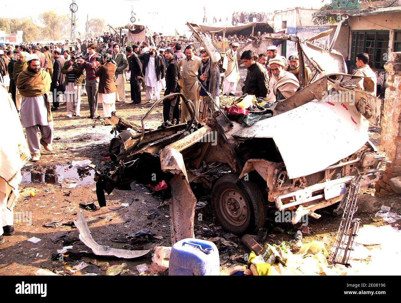 Local residents stand near the damage vehicles after blast in Jamrud Market in Jamrud, January 10, 2012 Pakistan, A bomb explosion killed at least 35 people and wounded more than 50 others in a tribal region of northwest Pakistan, officials saidon January 10, 2012. Photo by Irfan Ali/ABACAPRESS.COM Stock Photo