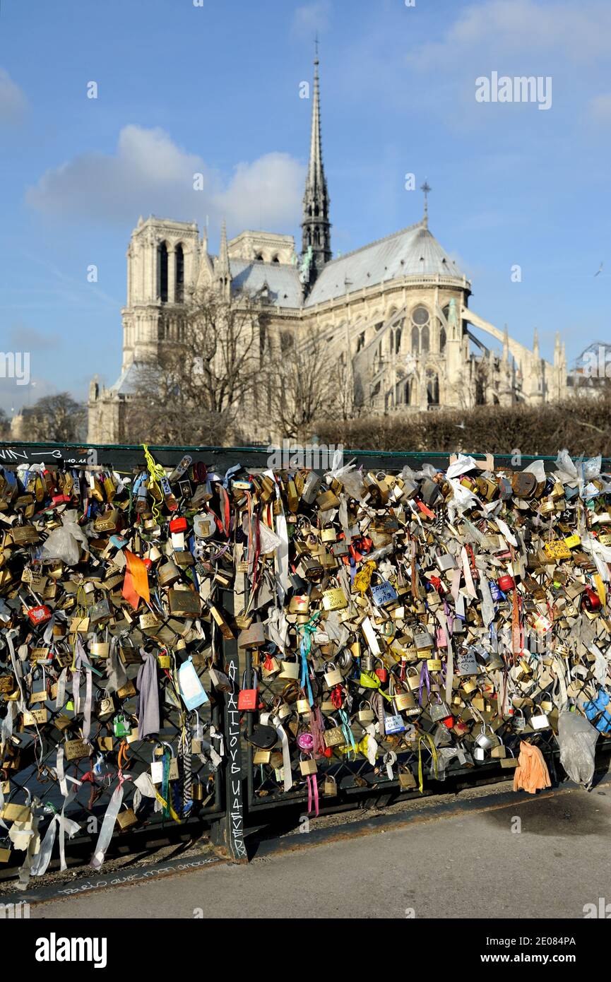 Love locks attached to a fence by lovers on the 'Pont de l'Archeveche'  bridge near Notre Dame church in Paris, France, on january 13, 2012. Photo  by Alban Wyters/ABACAPRESS.COM Stock Photo -