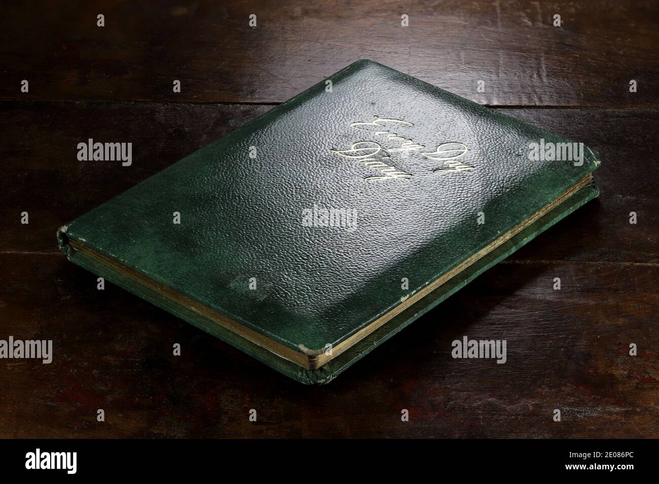 closed green diary with golden inscription on desktop Stock Photo Alamy