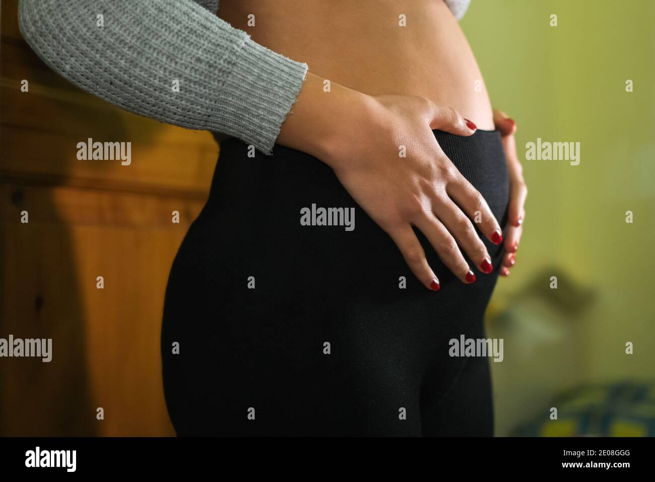 Happy pregnant mom woman touching baby bump belly,new born pregnancy lifestyle Stock Photo