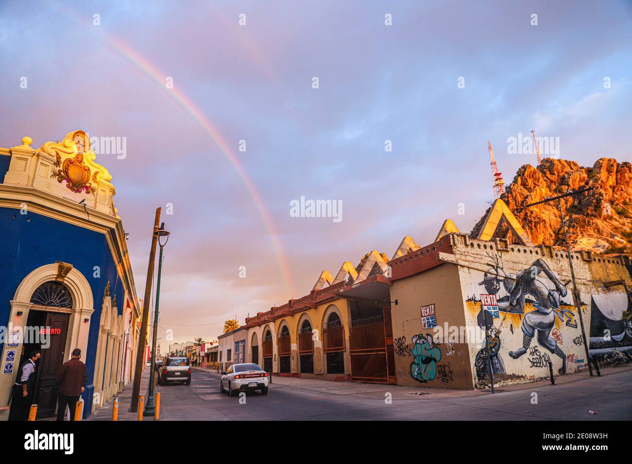 A rainbow is observed over the Barra Hidalgo bar or brewery on a cloudy day  during a winter afternoon on December 29, 2020 in Hermosillo, Mexico. Hill  of the bell (Photo by