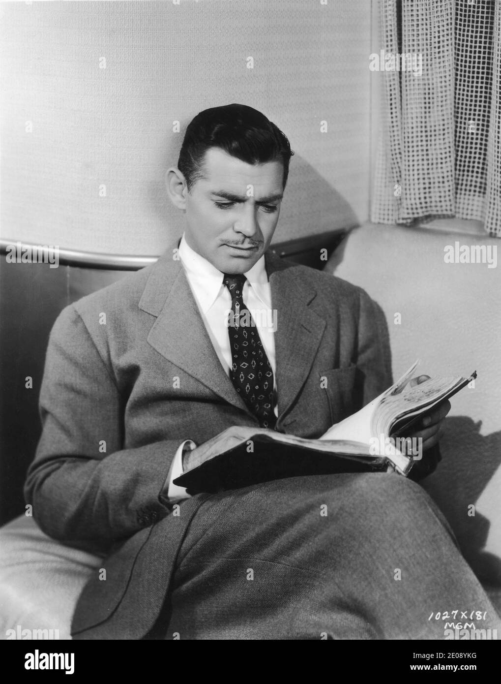 CLARK GABLE on set candid reading script during filming of TEST PILOT ...