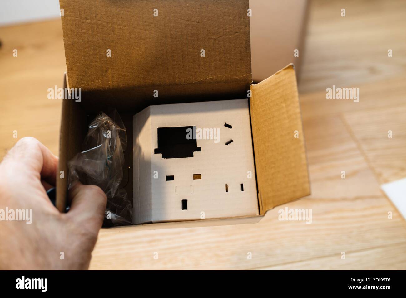 POV male hand holding cardboard carton box with designated places for