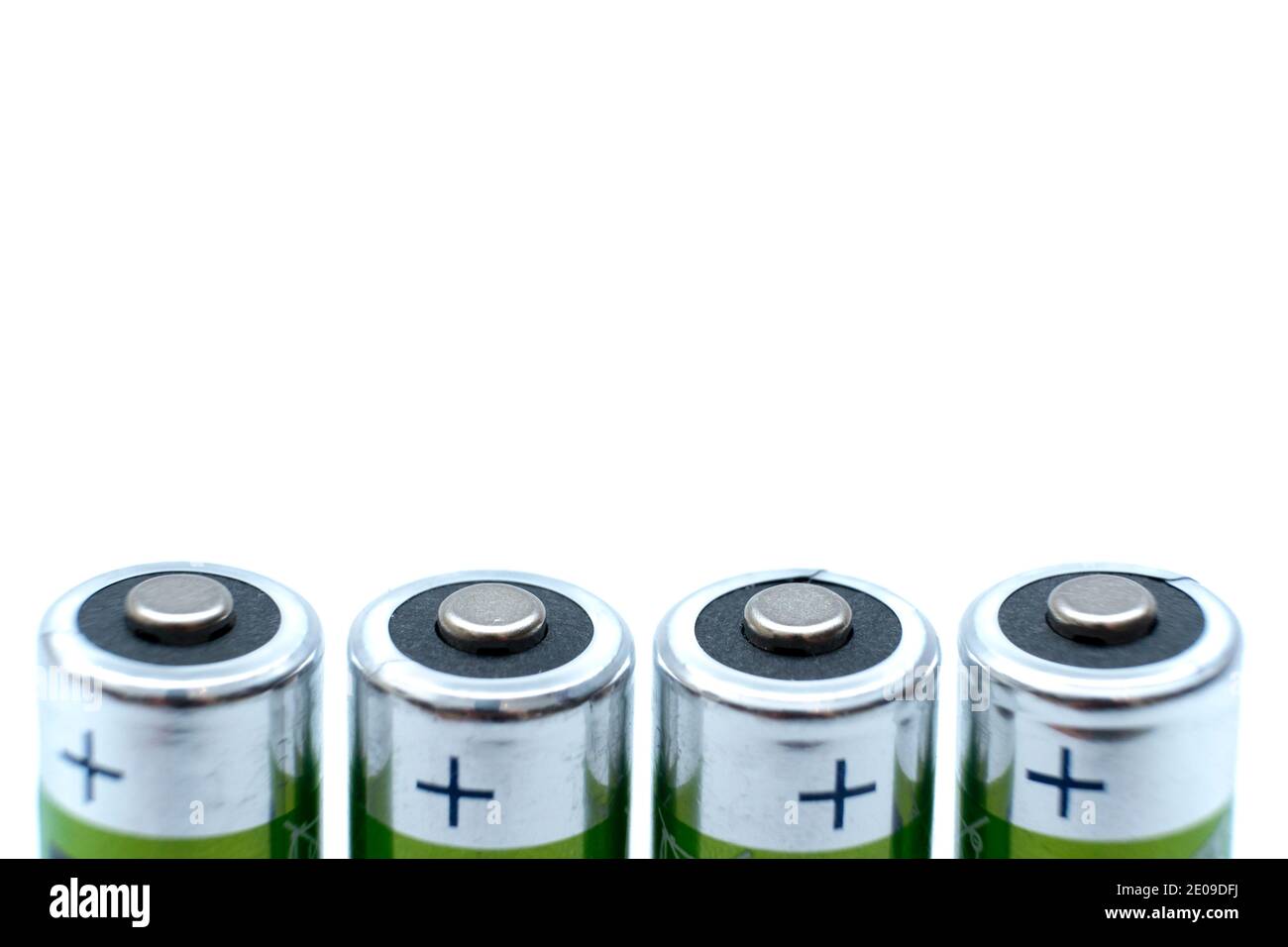four AA batteries plus poles close-up and white background Stock Photo ...