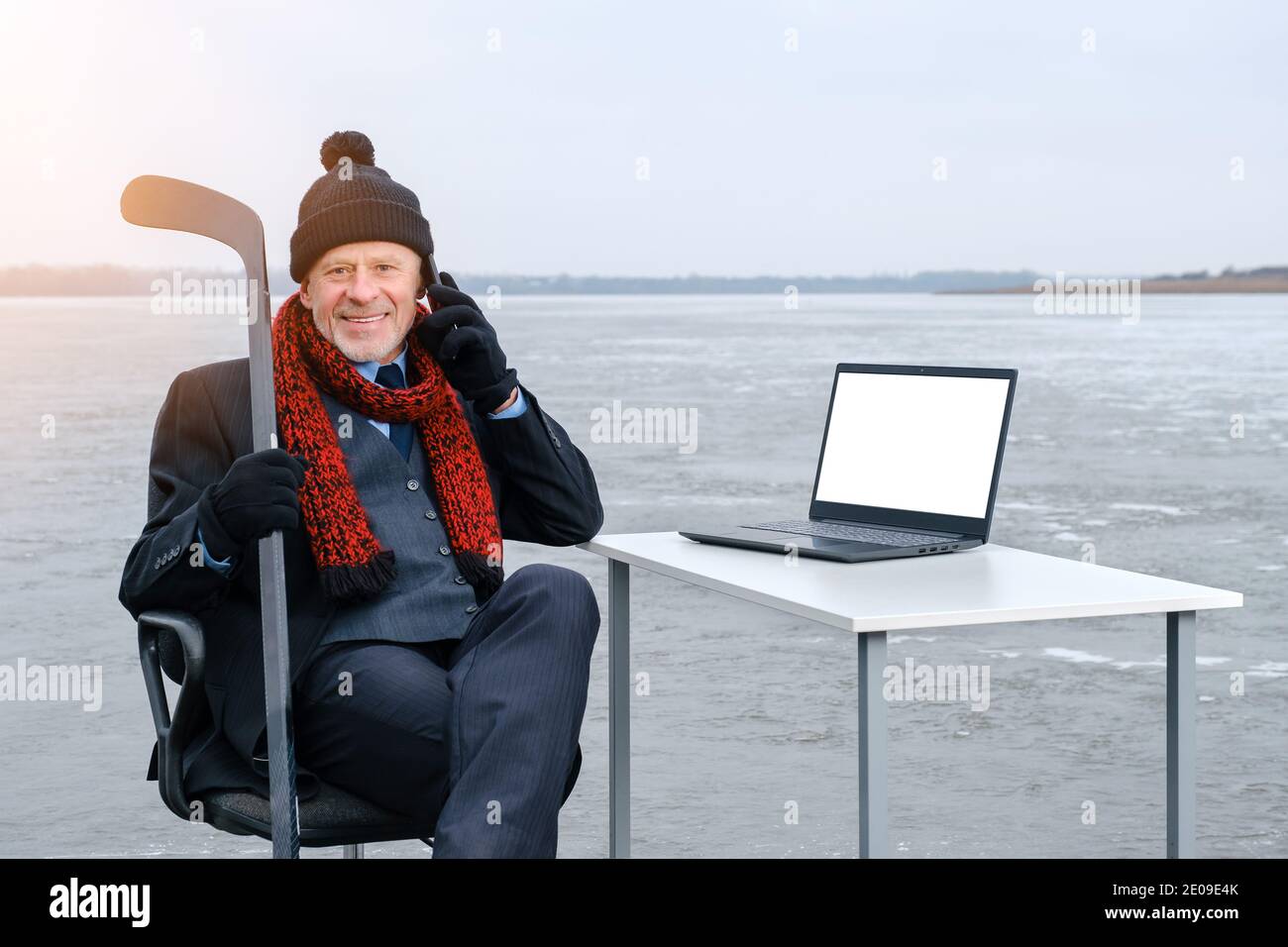 elderly gray-bearded businessman in suit, smiling while talking on smartphone Stock Photo