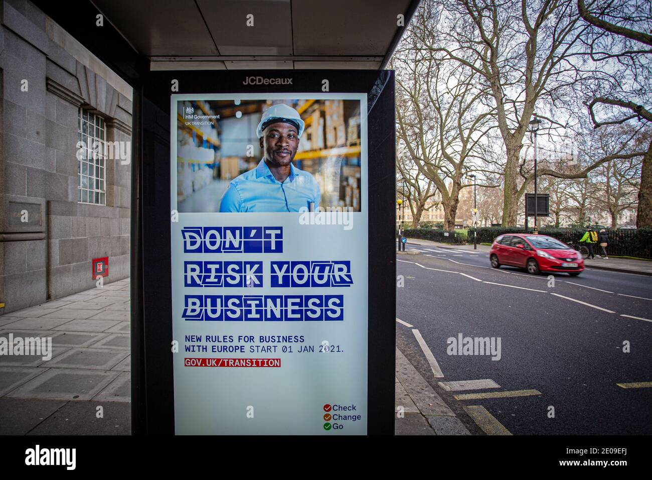 People drive past Brexit information posters in central London as MPs debate and vote on the UK-EU post-Brexit trade deal, on 30 December, 2020 . Stock Photo