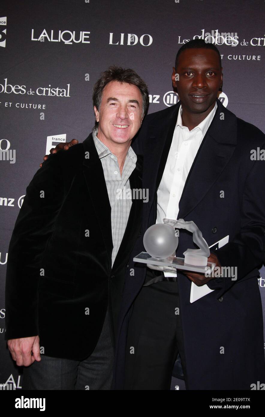 Francois Cluzet and Omar Sy posing in the press room at the 7th 'Globes de Cristal' awards held at the Lido in Paris, France, on February 6, 2012. Photo by Denis Guignebourg/ABACAPRESS.COM Stock Photo