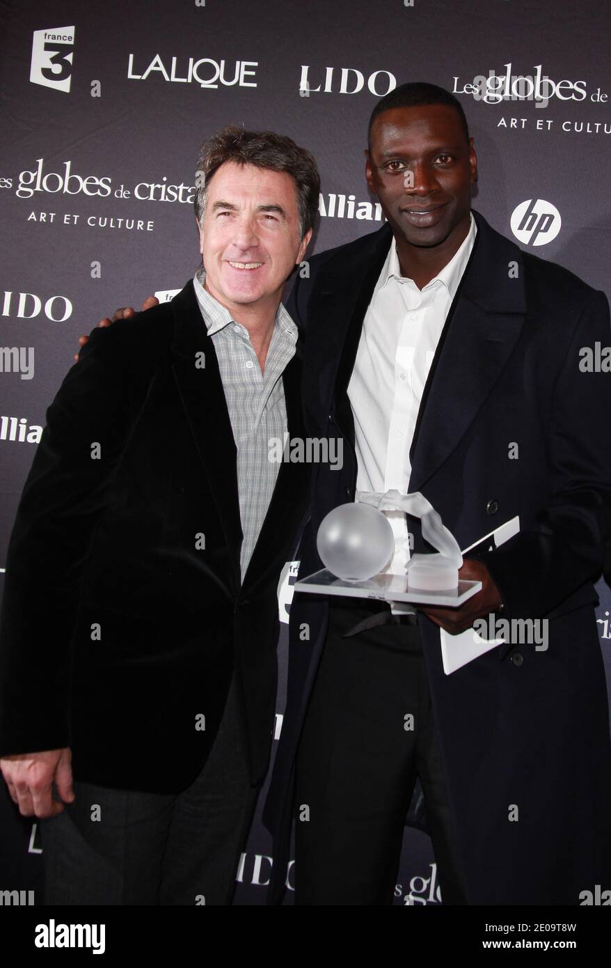 Francois Cluzet and Omar Sy posing in the press room at the 7th 'Globes de Cristal' awards held at the Lido in Paris, France, on February 6, 2012. Photo by Denis Guignebourg/ABACAPRESS.COM Stock Photo