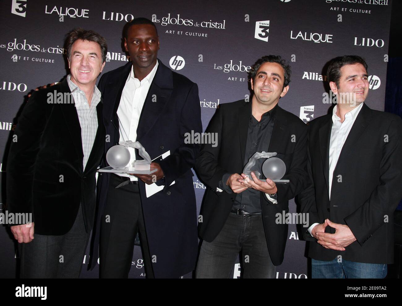 Francois Cluzet, Omar Sy, Eric Toledano and Olivier Nakache posing in the press room at the 7th 'Globes de Cristal' awards held at the Lido in Paris, France, on February 6, 2012. Photo by Denis Guignebourg/ABACAPRESS.COM Stock Photo
