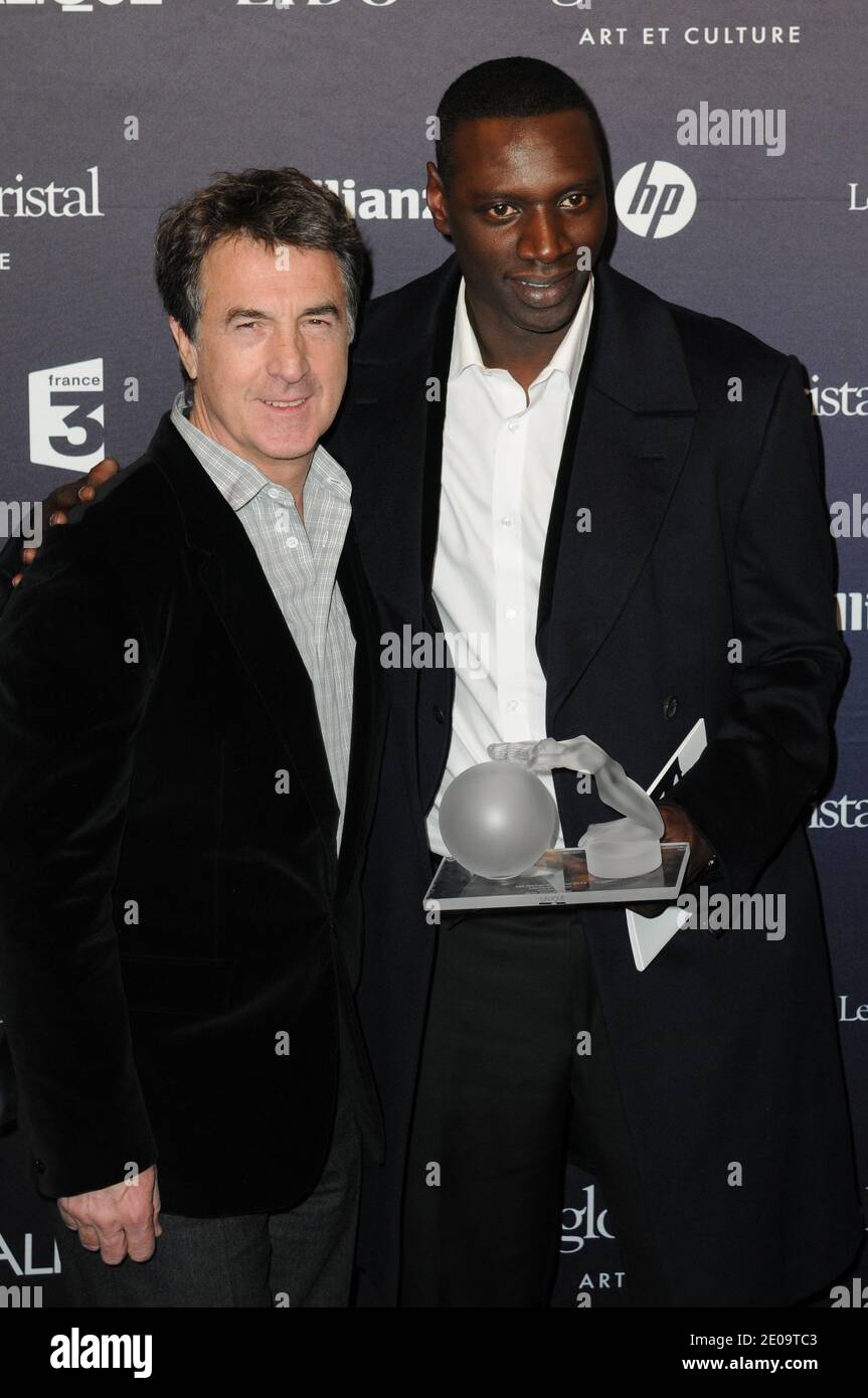Francois Cluzet and Omar Sy posing in the press room at the 7th 'Globes de Cristal' awards held at Le Lido in Paris, France, on February 6, 2012. Photo by Mireille Ampilhac/ABACAPRESS.COM Stock Photo