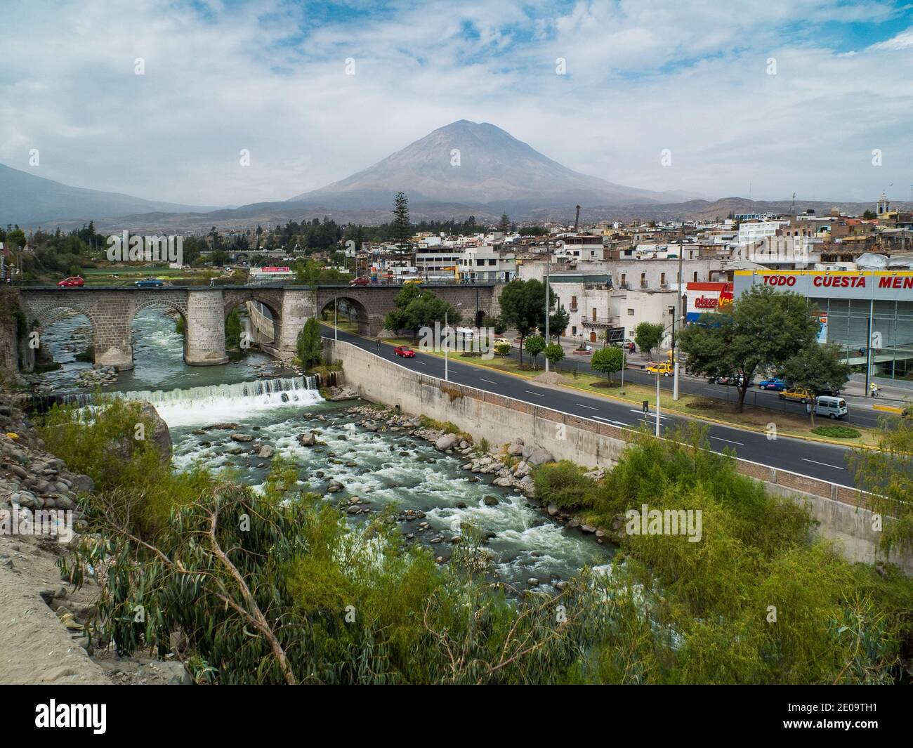The Rio Chili flowing through the city of Arequipa, Peru. The volcano Misti can be seen in the distance Stock Photo