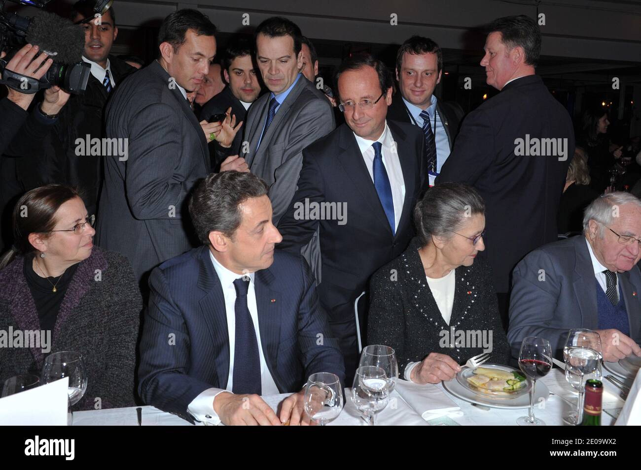 Socialist Party candidate for the 2012 French presidential election Francois Hollande arrives to speak with French President Nicolas Sarkozy as he sits near Aviva Shalit, Simone and Antoine Veil during the 'CRIF' (French Jewish community representative council) annual dinner, held at Pavillon d'Armenonville, in Paris, France on February 8, 2012. Photo by Christophe Guibbaud/ABACAPRESS.COM Stock Photo