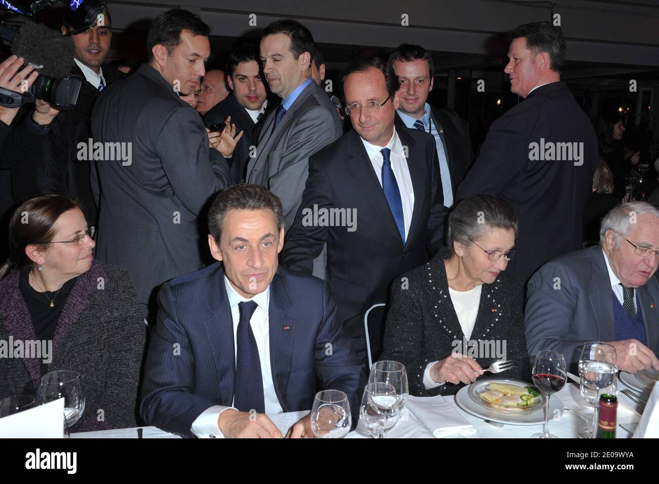 Socialist Party candidate for the 2012 French presidential election Francois Hollande arrives to speak with French President Nicolas Sarkozy as he sits near Aviva Shalit, Simone and Antoine Veil during the 'CRIF' (French Jewish community representative council) annual dinner, held at Pavillon d'Armenonville, in Paris, France on February 8, 2012. Photo by Christophe Guibbaud/ABACAPRESS.COM Stock Photo