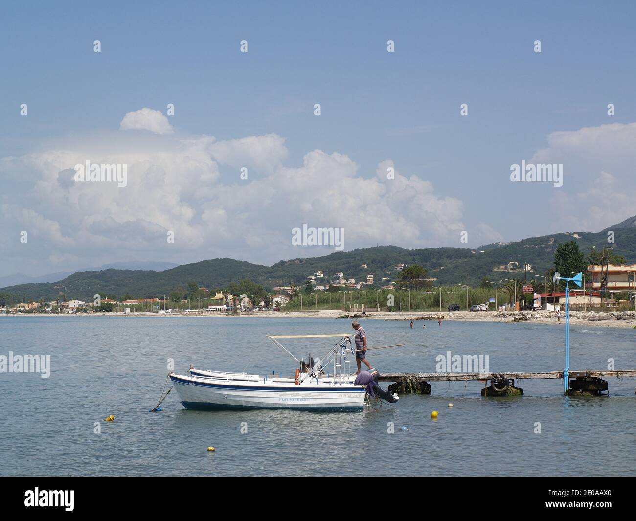 Man stepping onto hire boat, taken from The Boathouse, Roda, Corfu ...