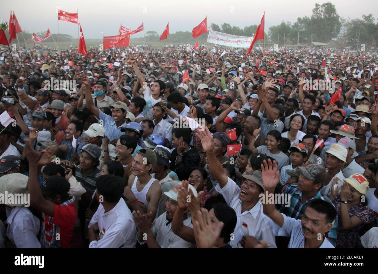 The crowd cheers Nobel Peace Prize winner and National League for Democracy [NLD] chairman Aung San Suu Kyi on campaign in Thongwa Township, 50 miles north of Yangon, the economical capital of Myanmar, Rangoon Region, Myanmar, on February 26, 2012. Her friend Su Su Lwin is running in this township. More than 30,000 people from nearby areas gathered along the road and fields to hear her speak. Su Su Lwin, one of the closest friend of Aung San Suu Kyi, is running for the lections in this township. Photo by Christophe Loviny/ABACAPRESS.COM Stock Photo