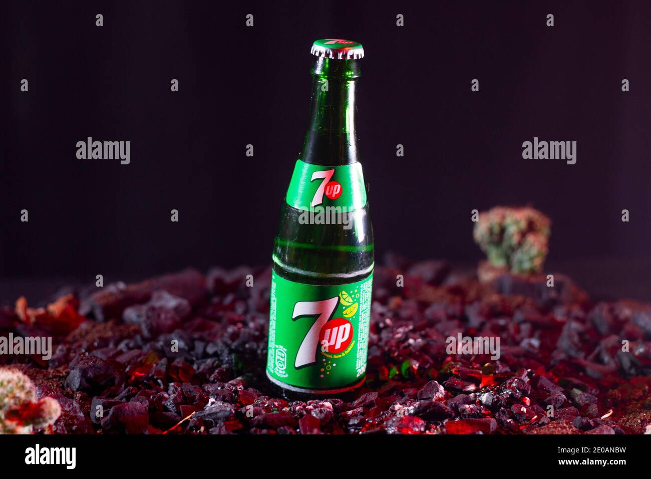 Coruna-Spain. Seven up soda bottle on dark wood shavings and cactus out of focus in the background on March 26, 2019 Stock Photo