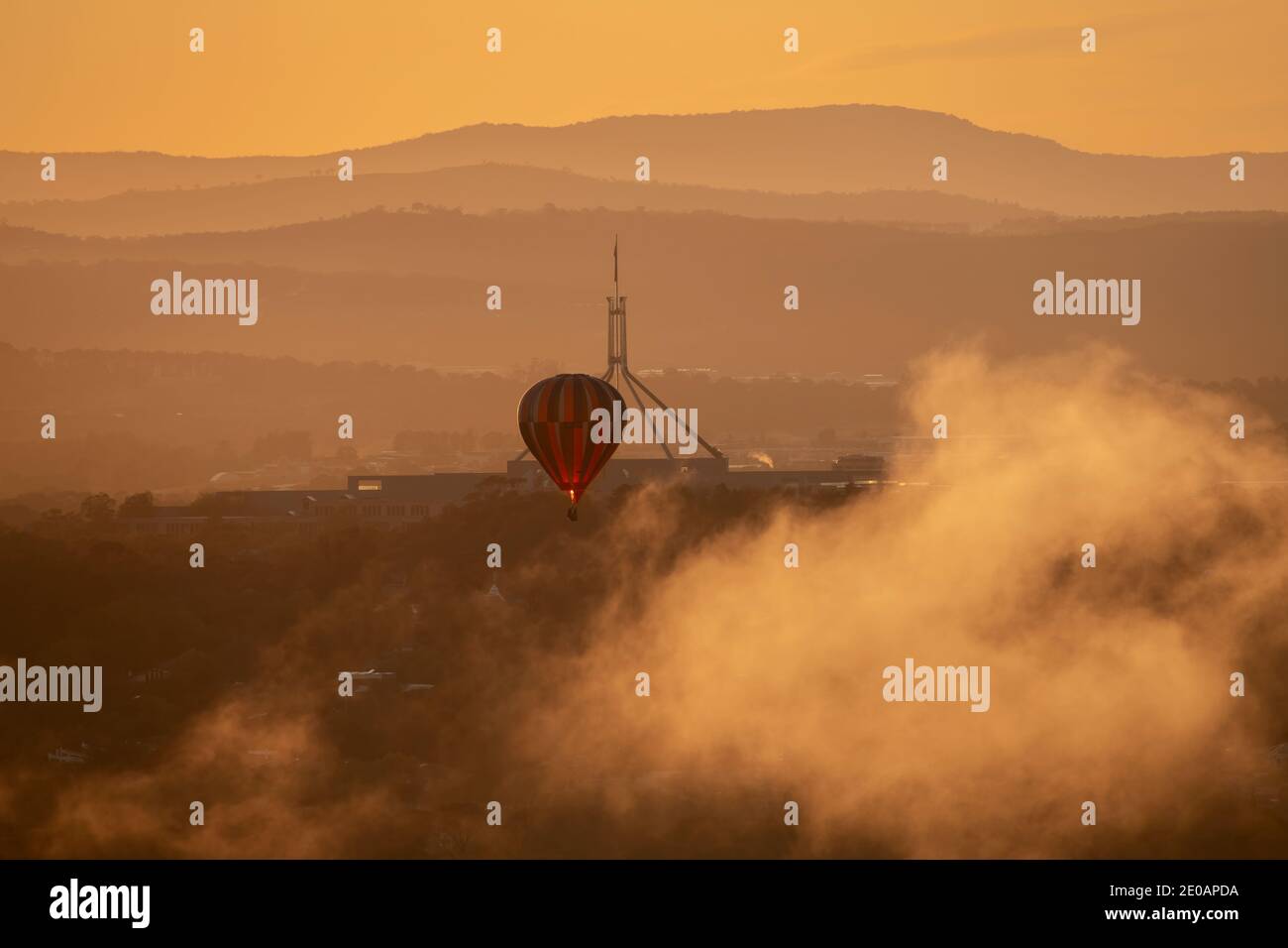 CANBERRA, 10th MARCH, 2020. Hot air balloon rising out of the clouds during the annual balloon festival. Editorial use. Stock Photo