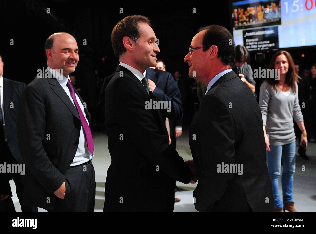 French opposition Socialist Party (PS) candidate for the 2012 presidential election Francois Hollande flanked by Pierre Moscovici speks with French journalist Fabien Namias before the TV broadcast show 'Des paroles et des actes' of French TV channel France 2 presented by French journalist David Pujadas in Saint-Denis La Plaine near Paris, France on March 15, 2012. Photo by Mousse/ABACAPRESS.COM Stock Photo