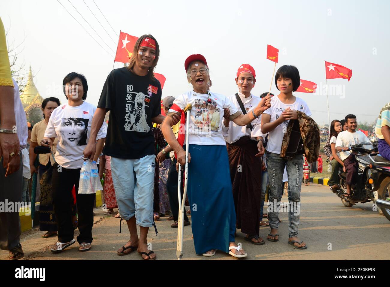 Supporters of all ages on their way to cheer Myanmar democracy campaigner Aung San Suu Kyi in front of Yandingaung pagoda in Lashi, Shan State. Lashio, Myanmar, on March 17, 2012. Photo by Christophe Loviny/ABACAPRESS.COM Stock Photo