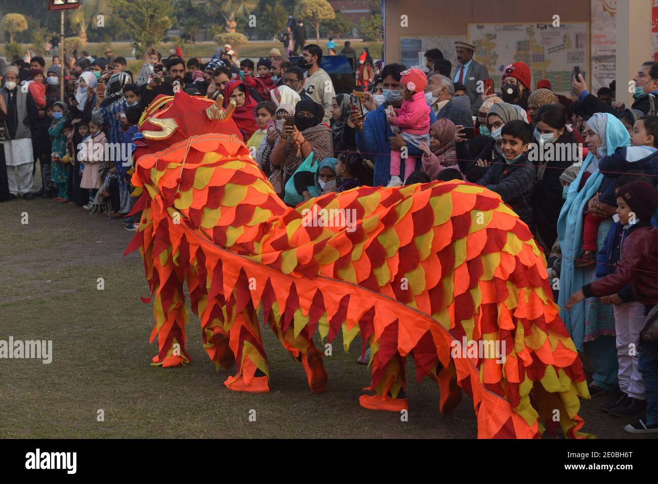 Pakistani large numbers of families sit in the ground take part during “Family Winters Festival” at Race Course Jilani Park in Lahore. Stock Photo