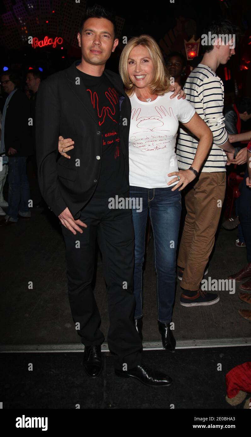 (L-R) Thierry Saint-Jean and Fabienne Amiach attending the 'Deux Mains Rouges' (2 Red Hands) party to the benefit of Sidaction in Paris, France March 26, 2012. Photo by Marco Vitchi/ABACAPRESS.COM Stock Photo