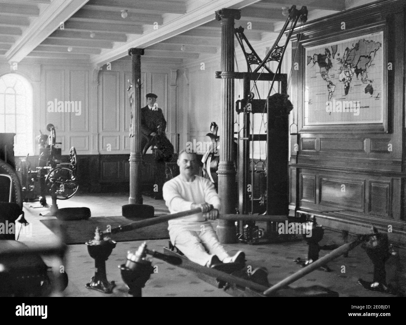 A photograph of TW McCawley, physical educator on a rowing machine and Harland & Wolffe, electrician William Parr on a mechanical camel in the Gymnasium of the RMS Titanic on display at 'Titanic, Return to Cherbourg' exhibition, at Cite de la Mer Museum in Cherbourg, western France in March 2012. The exhibition marking the 100th anniversary of the sinking of Titanic on April 14, 1912 is to open in April 2012.Titanic was built by Harland & Wolff in Belfast Ireland during 1910-1911 and later sank on April 15th, 1912 off the coast of New Foundland after striking an iceberg during her maiden voyag Stock Photo