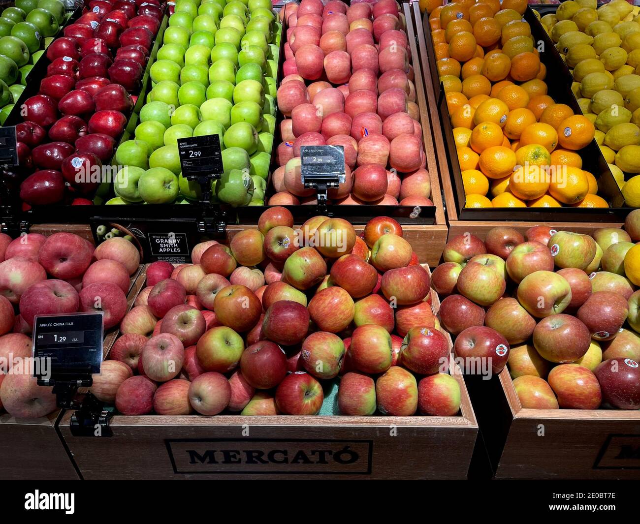 Variety of apples and oranges in boxes on city market. Healthy food