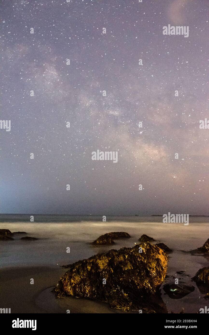 Rocky beach at night with the milky way Stock Photo - Alamy