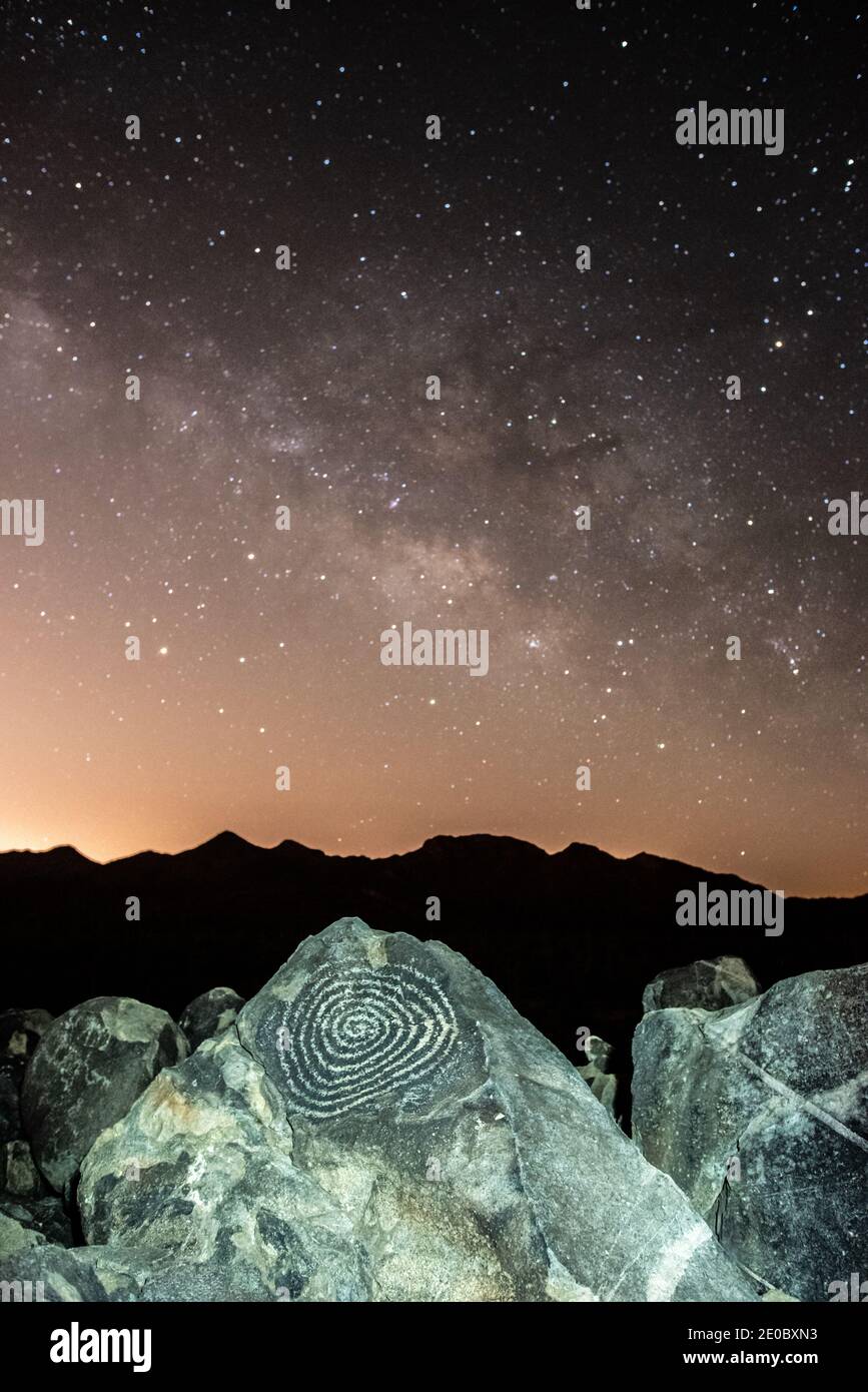 The Milky Way rises above ancient Hohokam petroglyphs Stock Photo