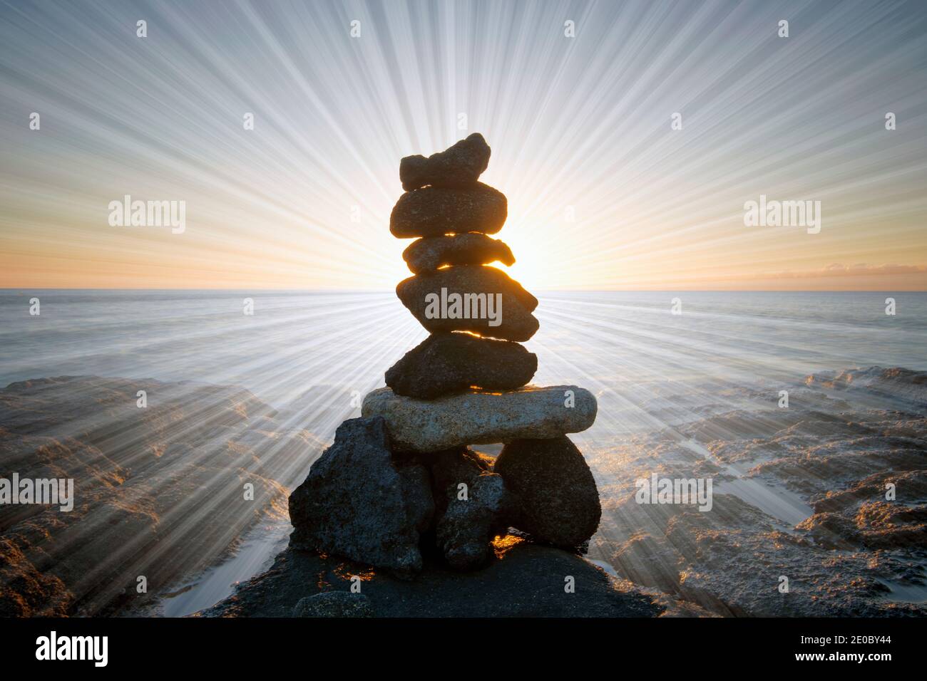Rock stack with light rays, on the beach at sunset. Big Island, Hawaii