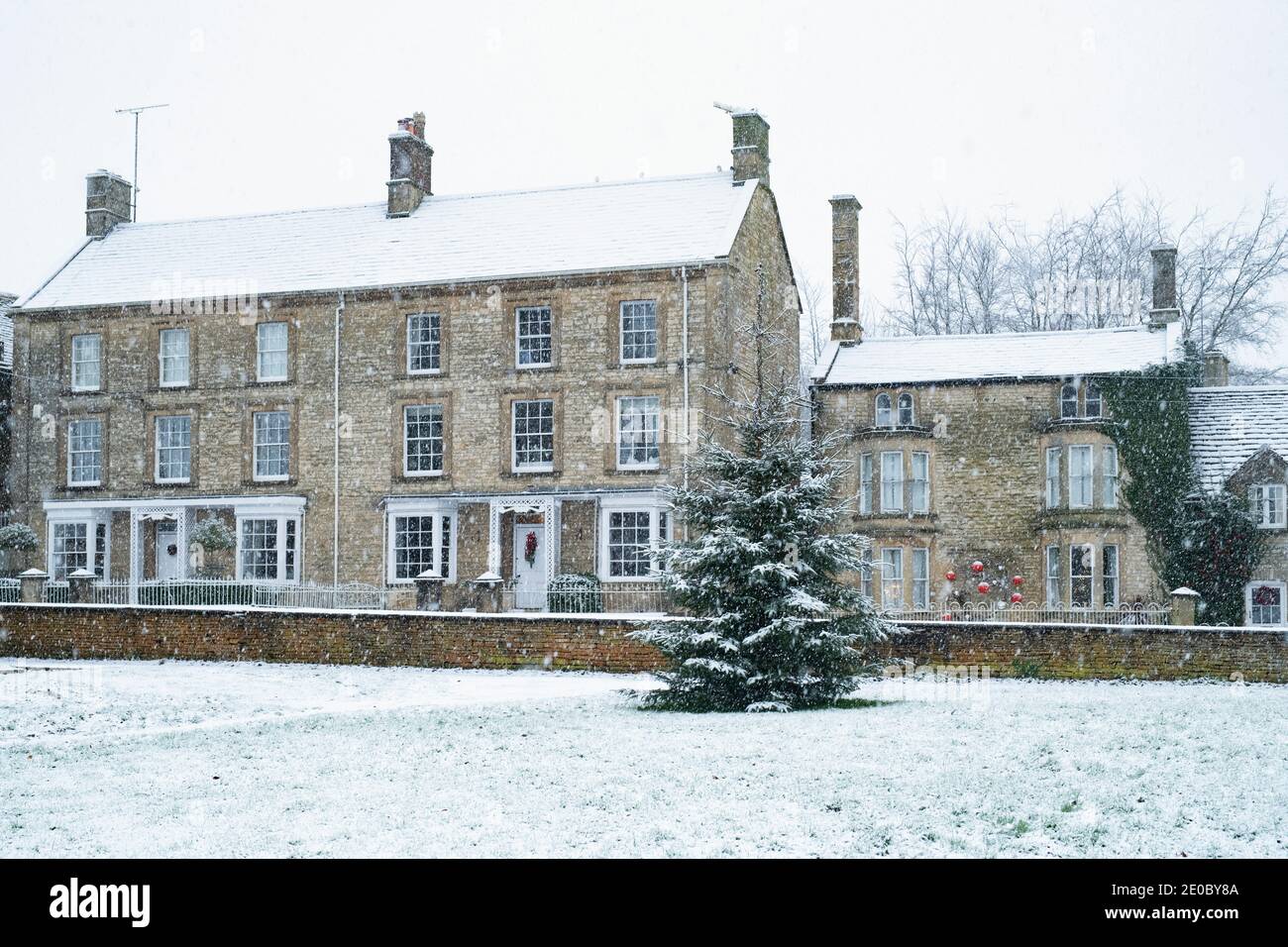 Shipton under Wychwood village Christmas tree in the snow. Shipton
