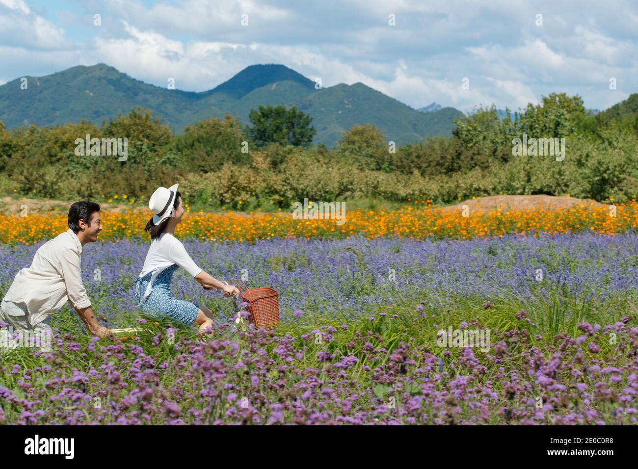 Young couples in the suburbs to ride a bicycle Stock Photo