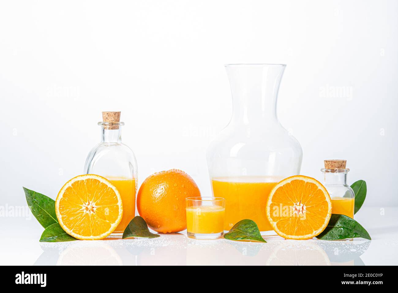 https://c8.alamy.com/comp/2E0C0YP/oranges-oranges-slices-orange-leaves-and-glass-containers-with-orange-juice-isolated-on-white-background-2E0C0YP.jpg