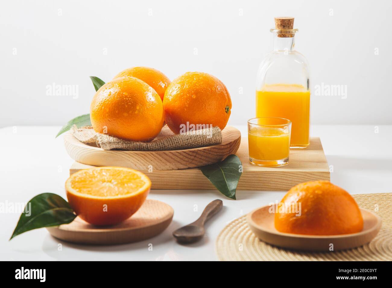 https://c8.alamy.com/comp/2E0C0YT/oranges-oranges-slices-orange-leaves-and-glass-containers-with-orange-juice-on-white-background-2E0C0YT.jpg