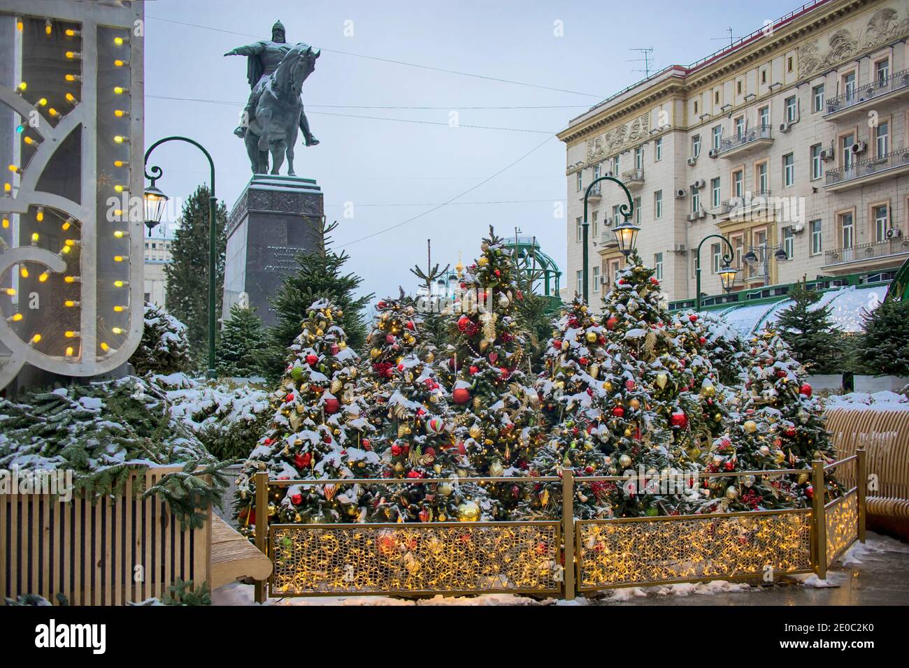 Moscow, Russia -30 December 2020, Yuri Dolgorukiy monument and Christmas/ New Year open air market with New Year Trees, shops and cafes 'Journey to Ch Stock Photo