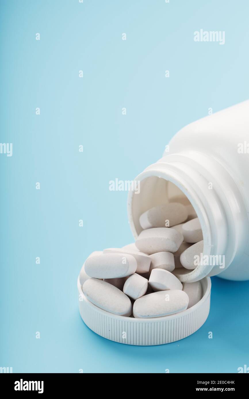 Vitamins and minerals in white capsules fell out of a ...