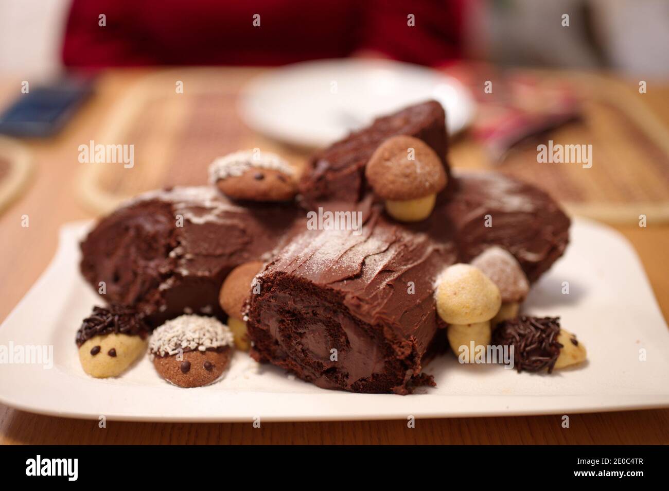 Decorated Christmas chocolate cake with cookies on white plate Stock Photo