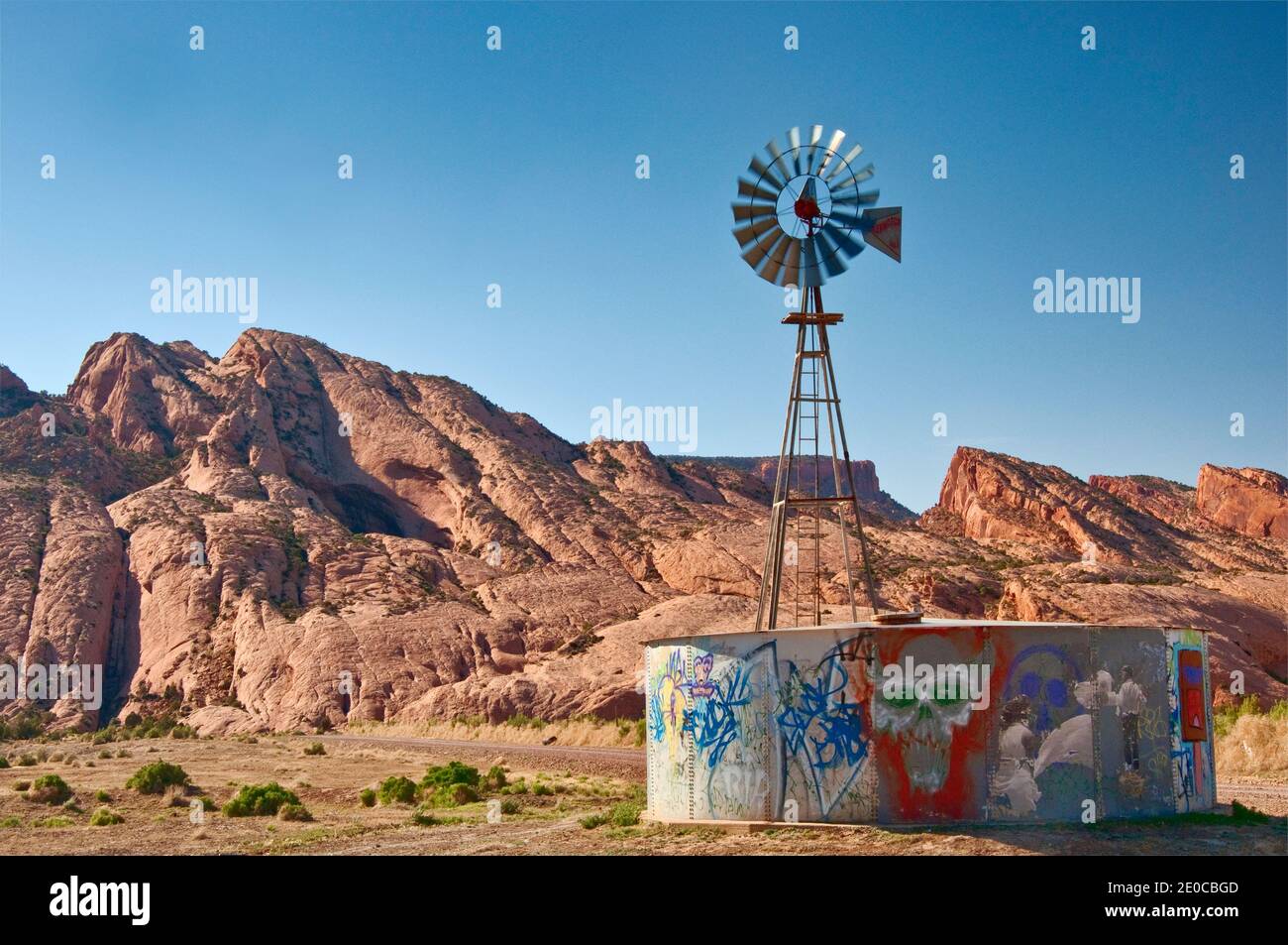Windmill and water tank, Skeleton Mesa behind, Navajo Indian