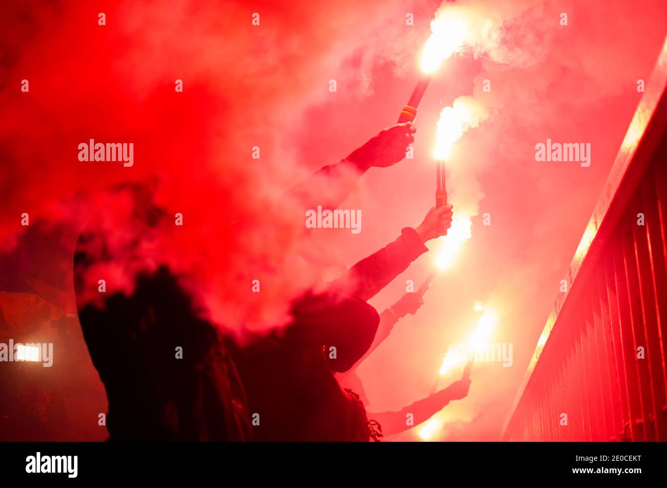 The protester is holding a fiery fire in his hands. Football fan burns fire Stock Photo