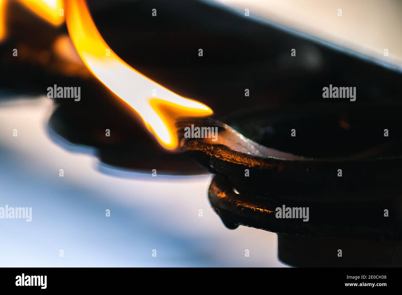 Burning clay oil lamps, glowing with the wind in the dark, offering light to Lord Buddha Stock