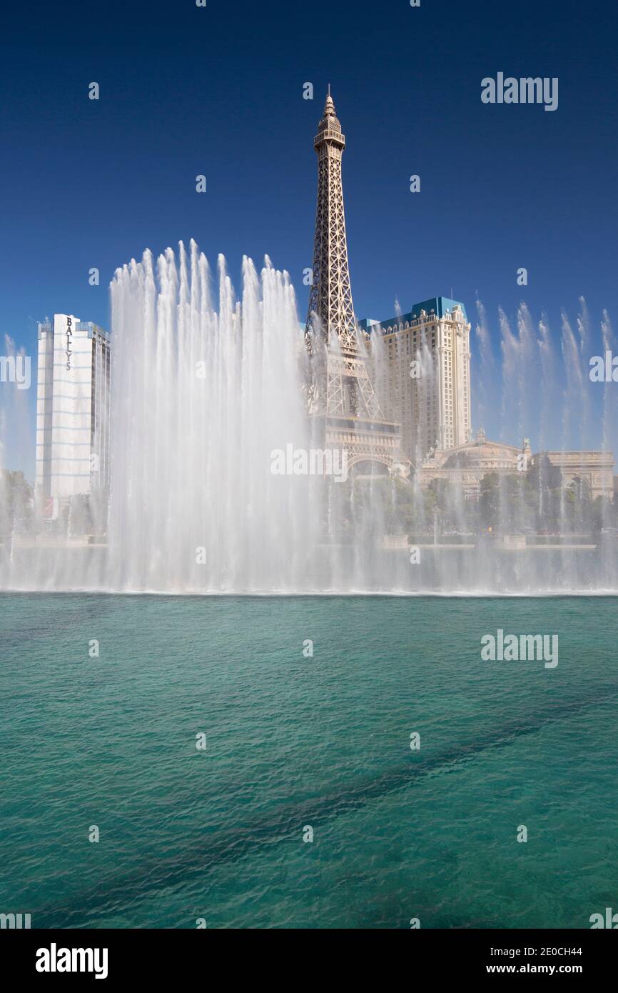 View across lake to replica Eiffel Tower at the Paris Hotel and Casino, Bellagio fountains in foreground, Las Vegas, Nevada, United States of America Stock Photo