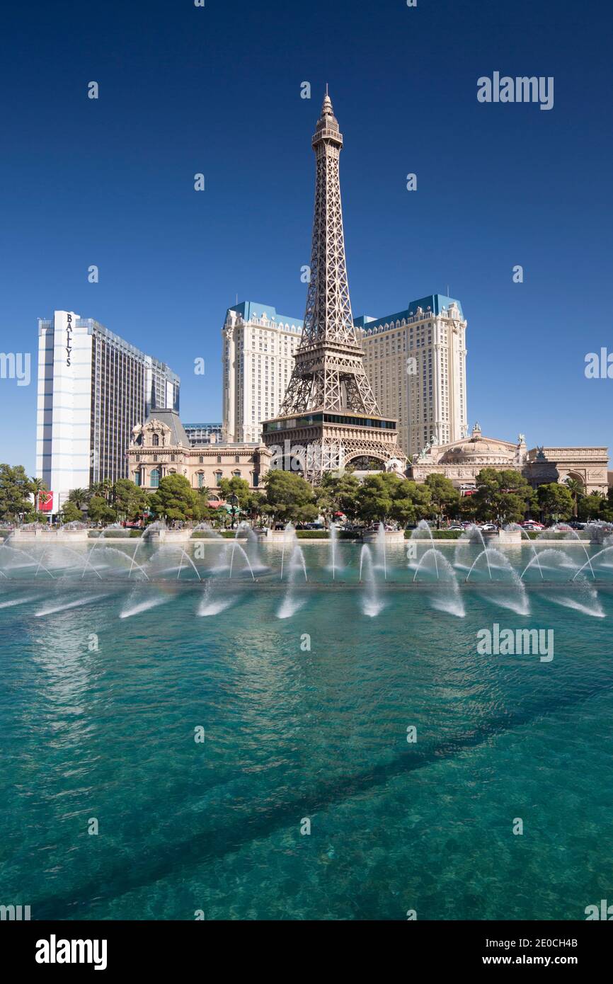 View across lake to replica Eiffel Tower at the Paris Hotel and Casino, Bellagio fountains in foreground, Las Vegas, Nevada, United States of America Stock Photo