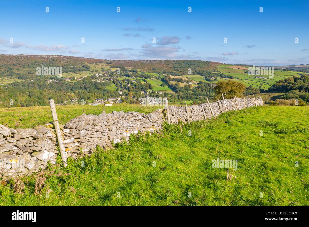 View of dry stone wall and Calver Village overlooked by Curbar Edge, Calver, Derbyshire Peak District, Derbyshire, England, United Kingdom, Europe Stock Photo
