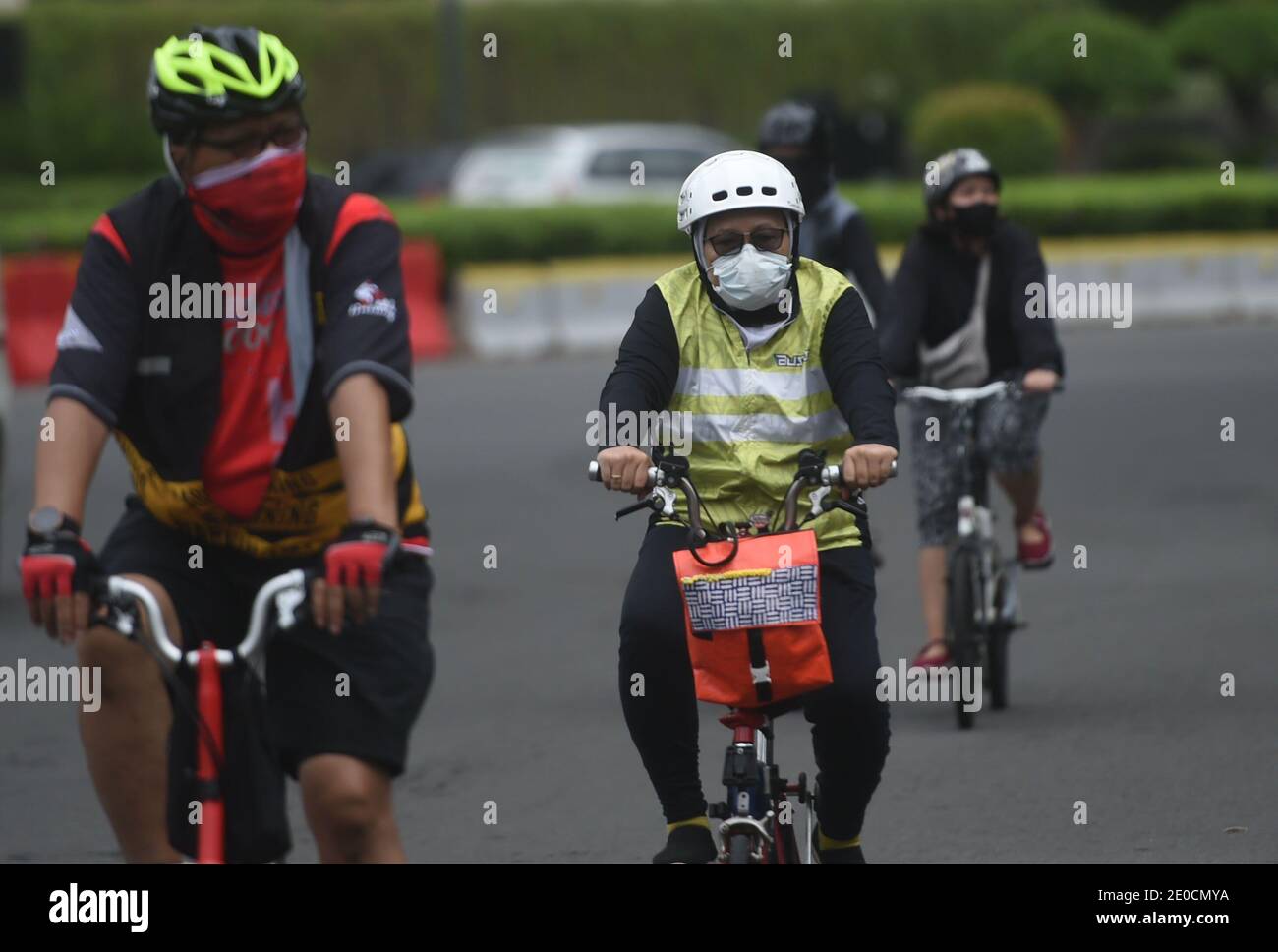 Jakarta, Indonesia. 31st Dec, 2020. People wearing face masks ride bicycles in Jakarta, Indonesia, Dec. 31, 2020. The COVID-19 cases in Indonesia rose by 8,074 within one day to 743,198, with the death toll adding by 194 to 22,138, the Health Ministry said on Thursday. Credit: Zulkarnain/Xinhua/Alamy Live News Stock Photo