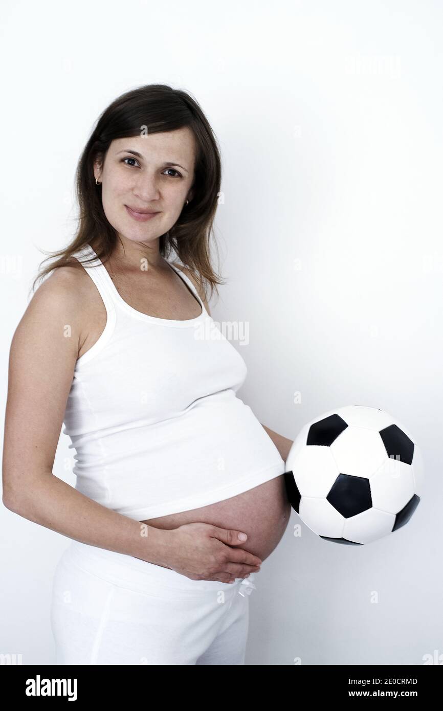 GREAT BRITAIN / England / London / Pregnant woman with soccerball Stock Photo