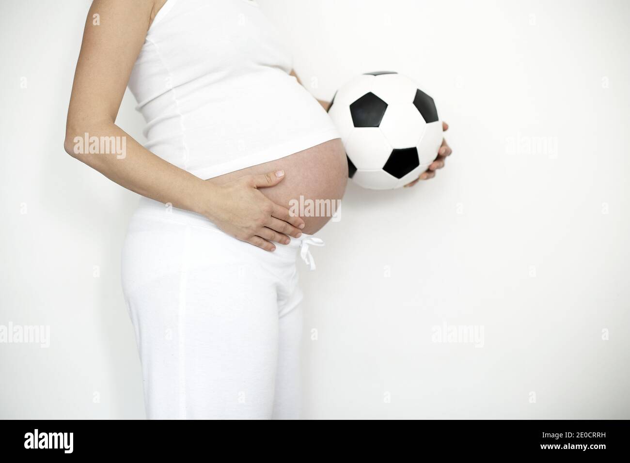 GREAT BRITAIN / England / London / Pregnant woman with soccerball Stock Photo