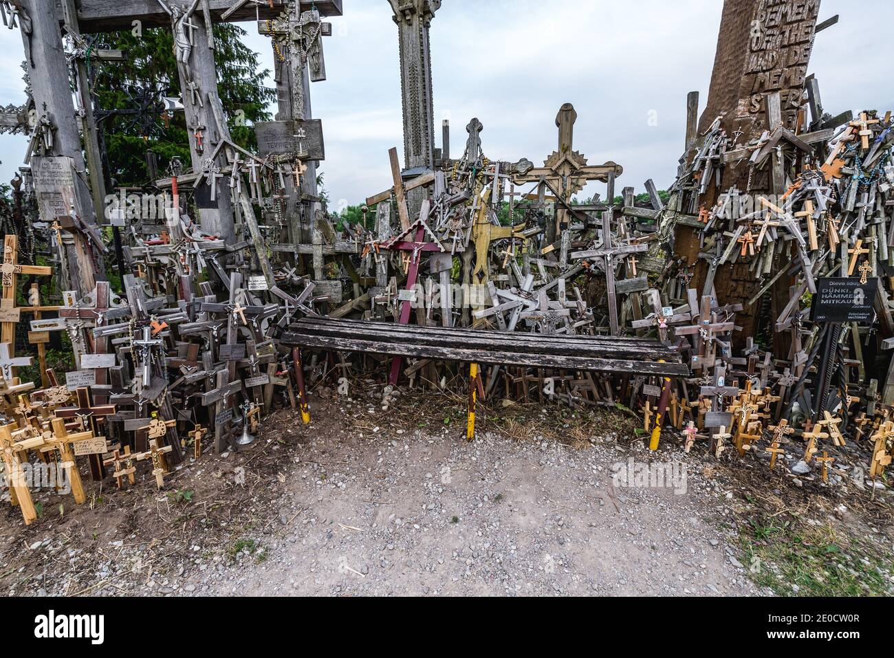 Wooden bench on top of Hill of Crosses in Lithuania Stock Photo
